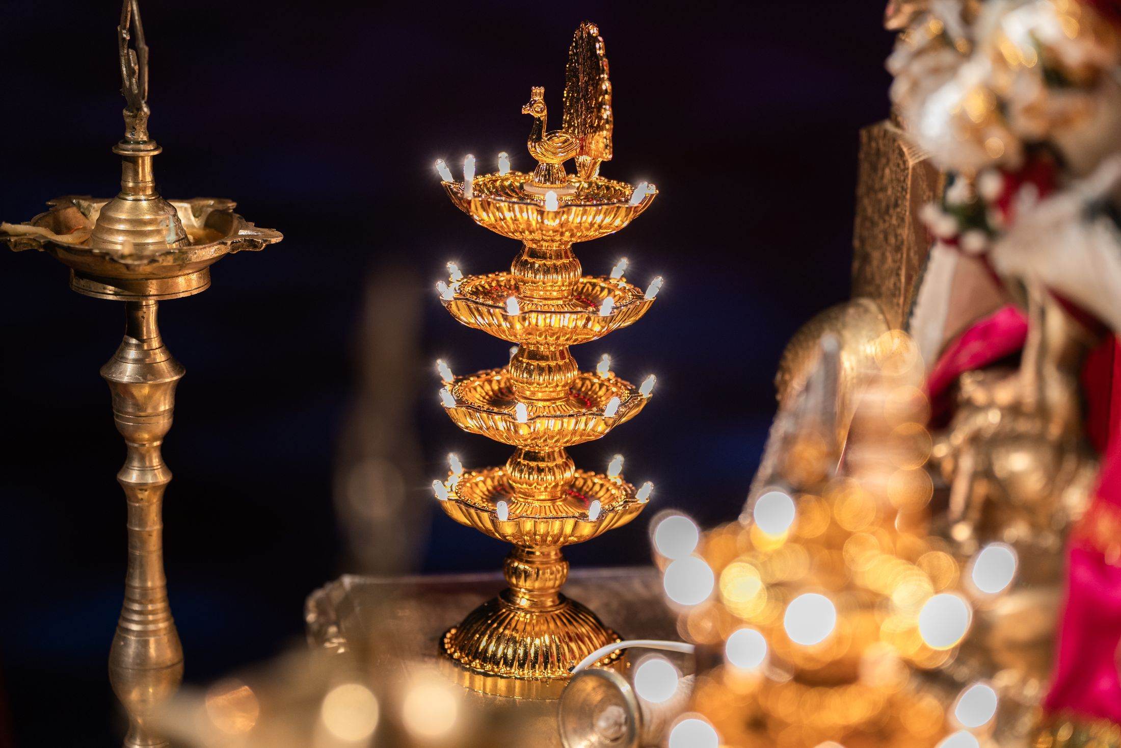 Traditional brass lamps glowing beside festive decorations